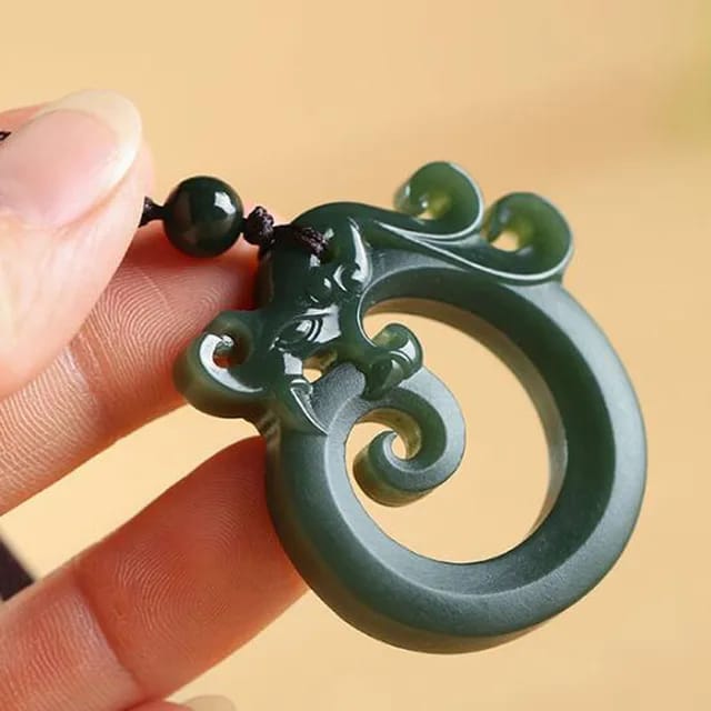 Elegant Chinese jade dragon pendant for men, featuring traditional carving styles on a natural jade backdrop, ideal for collectors.