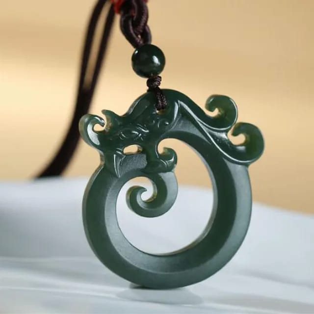 Stylish men's Chinese jade dragon necklace pendant, displayed on a wooden texture, merging ancient symbolism with modern fashion.