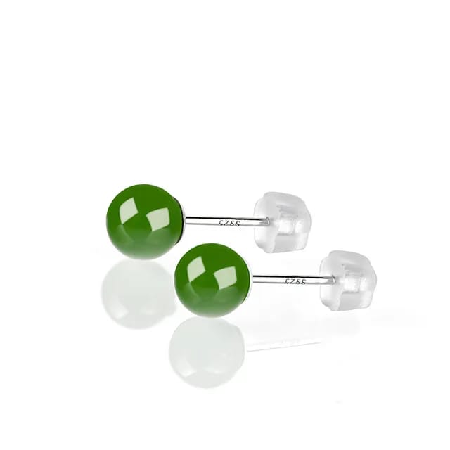 Angled view of Jade Hunt's Green Jade Earrings, highlighting the fine polish on the natural emerald jade and the hypoallergenic S925 silver posts, against a white backdrop.