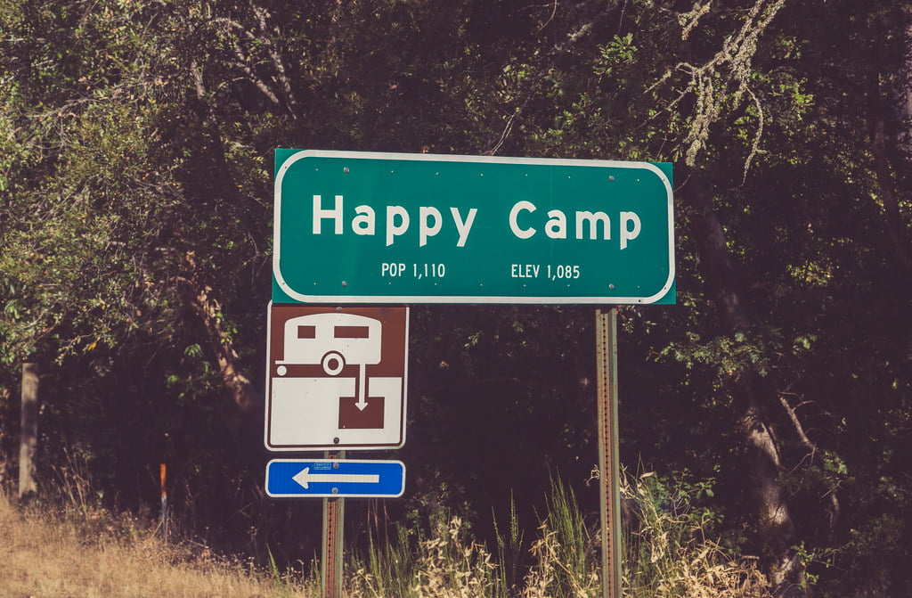 A highway sign for the small town of Happy Camp, California.