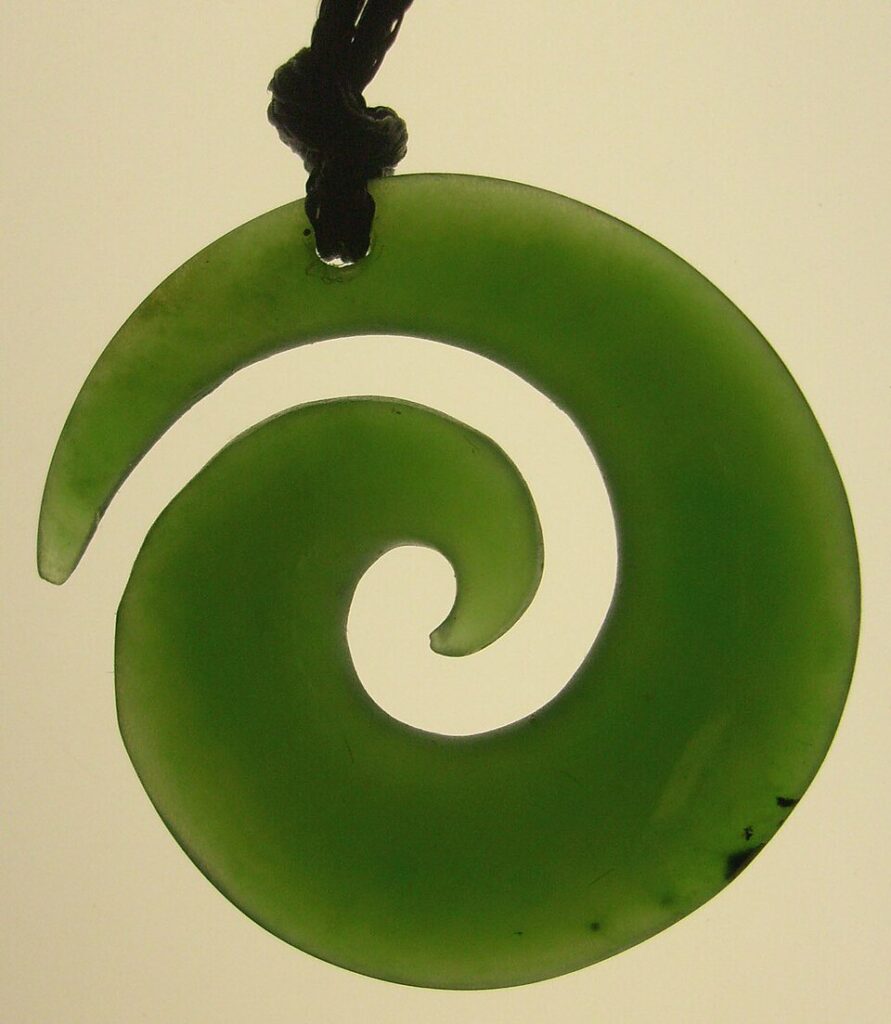 Green nephrite pendant, green, carved in a Māori Style spiral, on cord